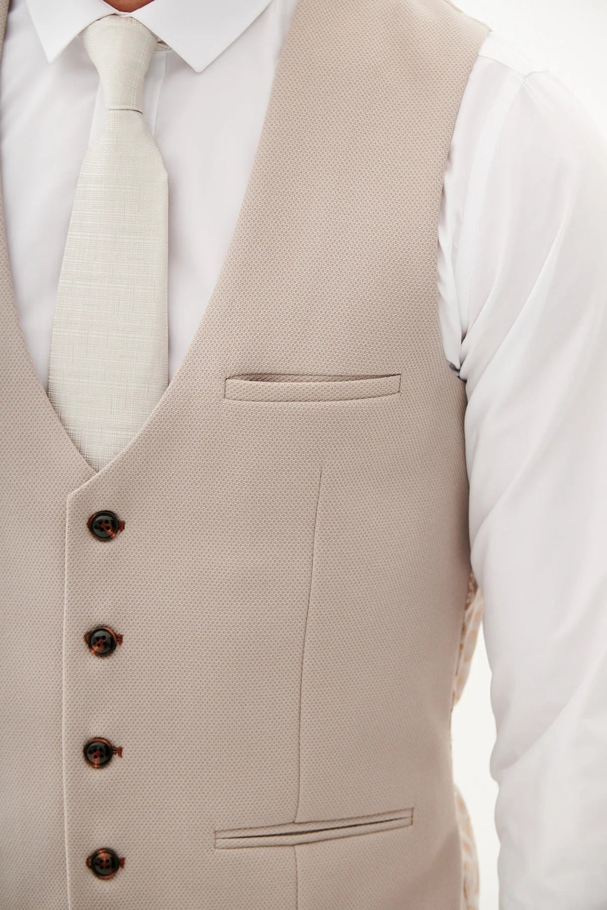 Beige vest with buttons on a white shirt background